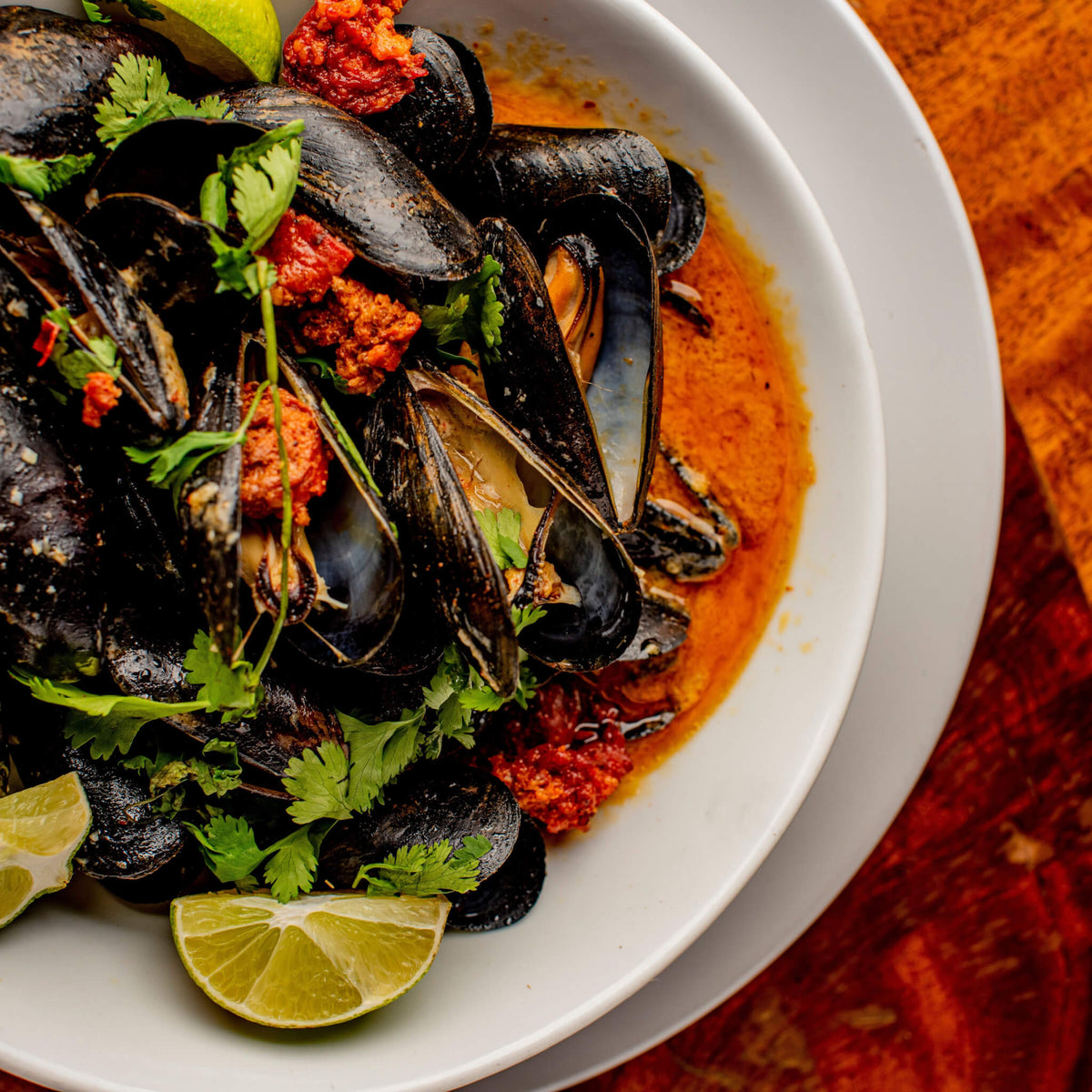 spoon mussels into bowls and pour over with broth. Garnish with chopped ...