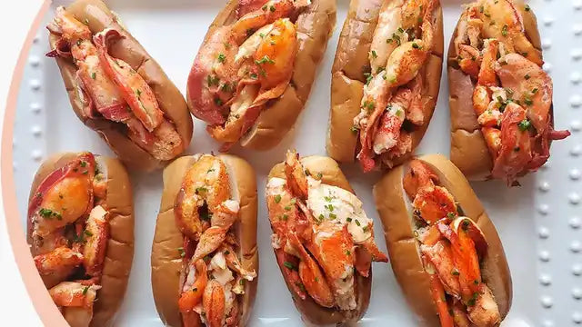 Lobster rolls on a white plate with a textured surface