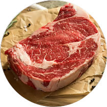 Raw Black Angus Steak on a wooden cutting board